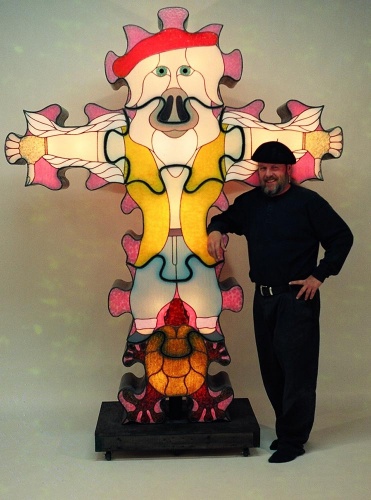 Barry Haver standing next to one of his glass sculptures